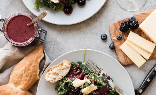 Blackberry and blueberry kale salad with Aged Havarti and berry dressing