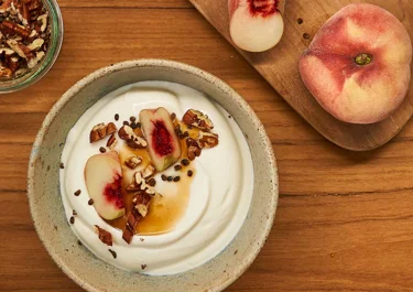 Skyr bowl with peach, pecan, and cardamom