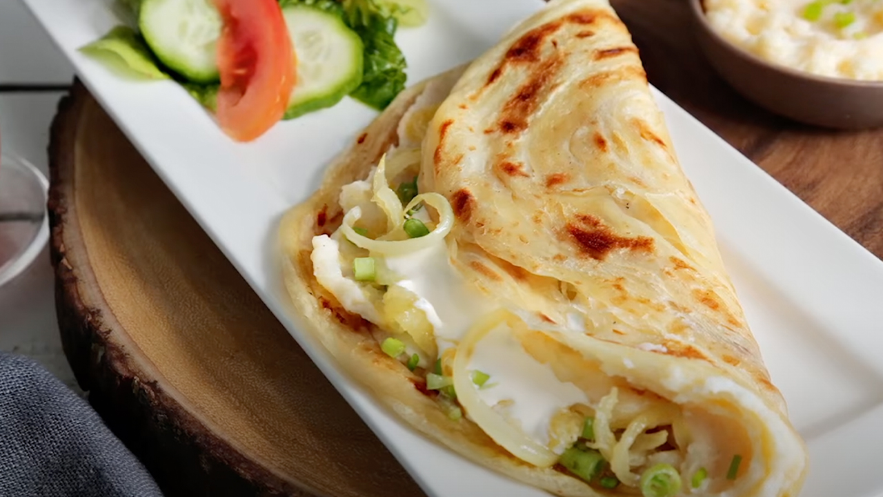 Paratha with cream cheese, fried onions, mashed potatoes with salt & slight sprinkle of red chilli p