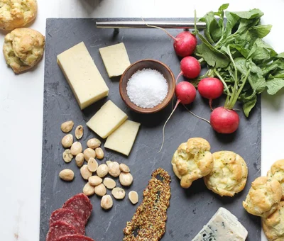 Spring cheese board with herb and pickled ramp gougeres