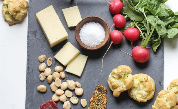 Spring cheese board with herb and pickled ramp gougeres