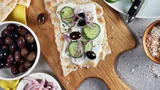 Tameez bread with cream cheese, cucumbers, olives and lime-pickled onions