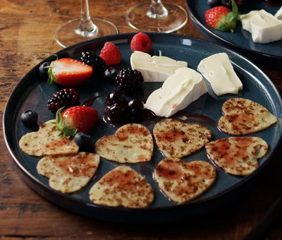 Heart-shaped pancakes with Creamy White and berries