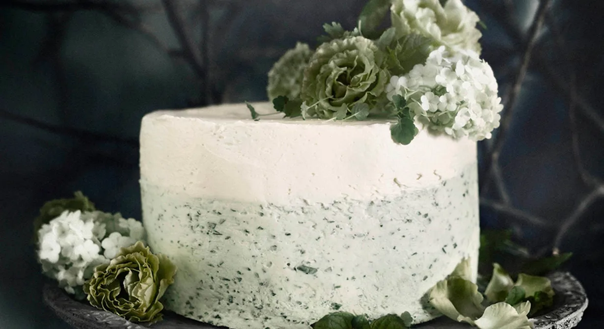 Vår variant av morotskaka är spetsad med rårivna äpplen och toppas med en citronfrisk färskostfrosting som dekoreras med blad av mynta, dill, koriander, persilja och spenat.