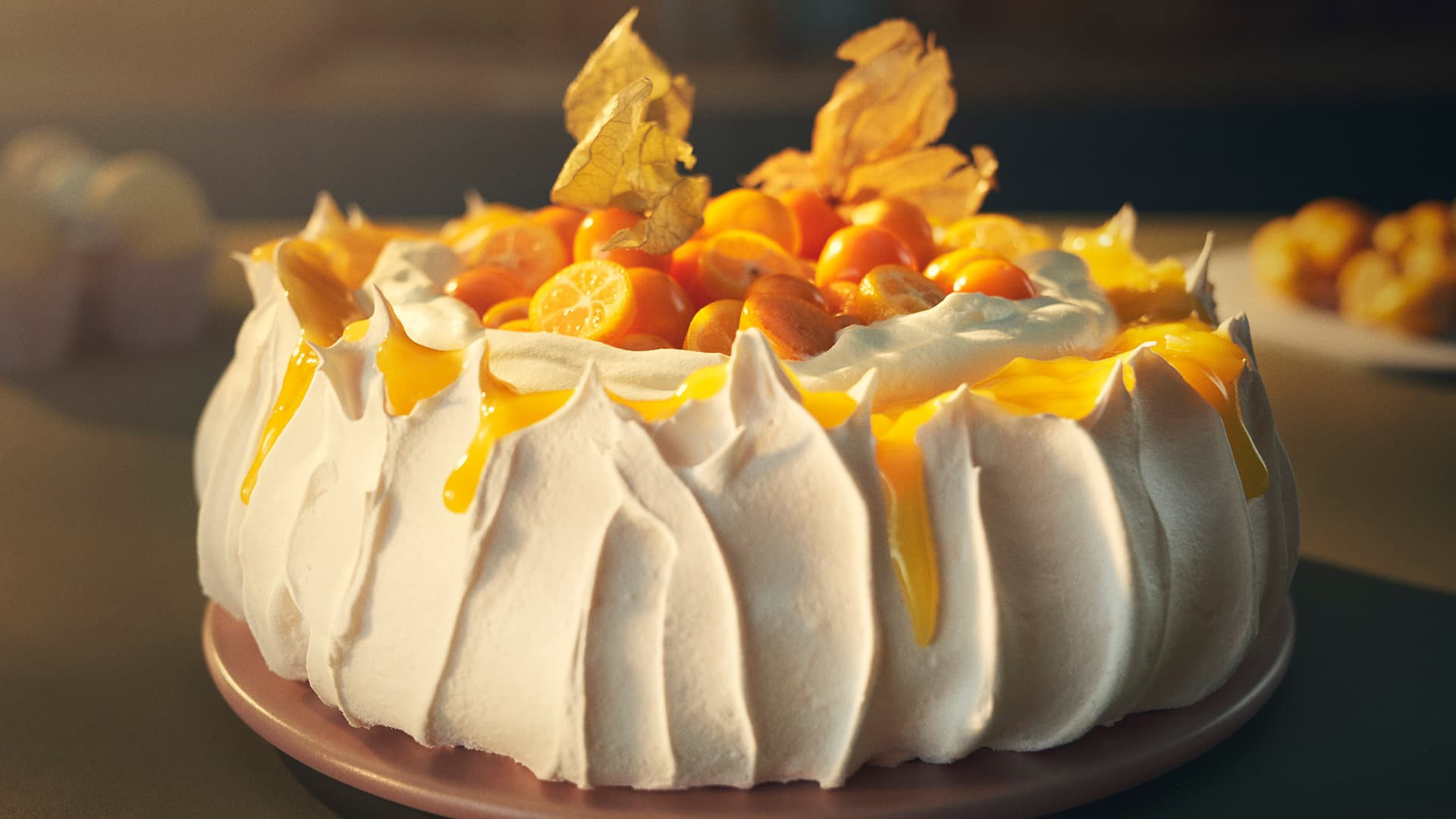 Christmas pavlova with lemon curd, candied kumquats, and cape gooseberries