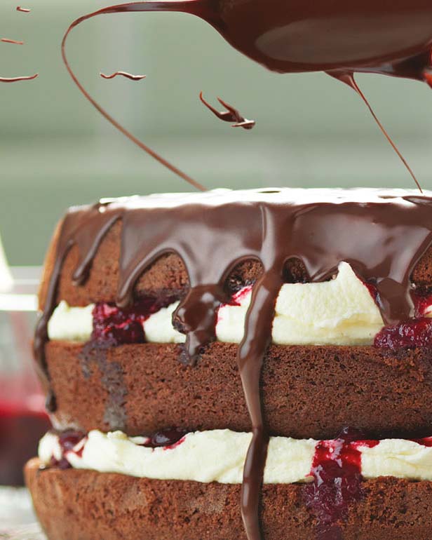 CHOCOLATE CAKE WITH A BUTTER ICING AND CHERRY COMPOTE