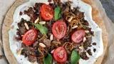 Arabic bread with cream cheese, minced meat, caramelized onions, tomatoes and mint