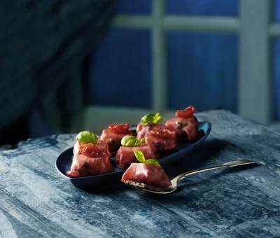 Small bresaola packages with Double Cream Brie and olives