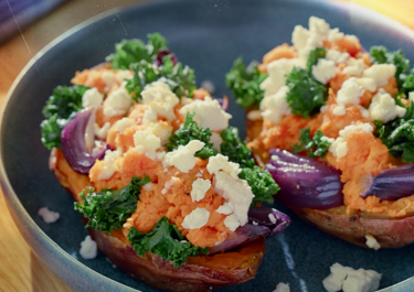 Baked sweet potatoes with onion, kale and cheese