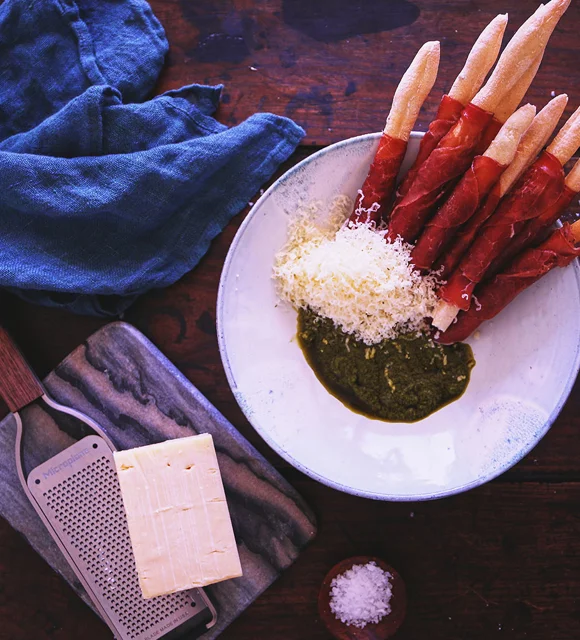 Bresaola wrapped grissini with Cheddar and basil sauce
