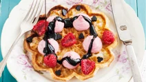 Waffles with whipped raspberry panna cotta and liquorice sauce