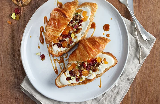 Croissants with cream cheese, dried fruits and nuts