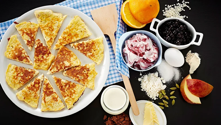 Rice pudding pancakes with apples and blackcurrant cream