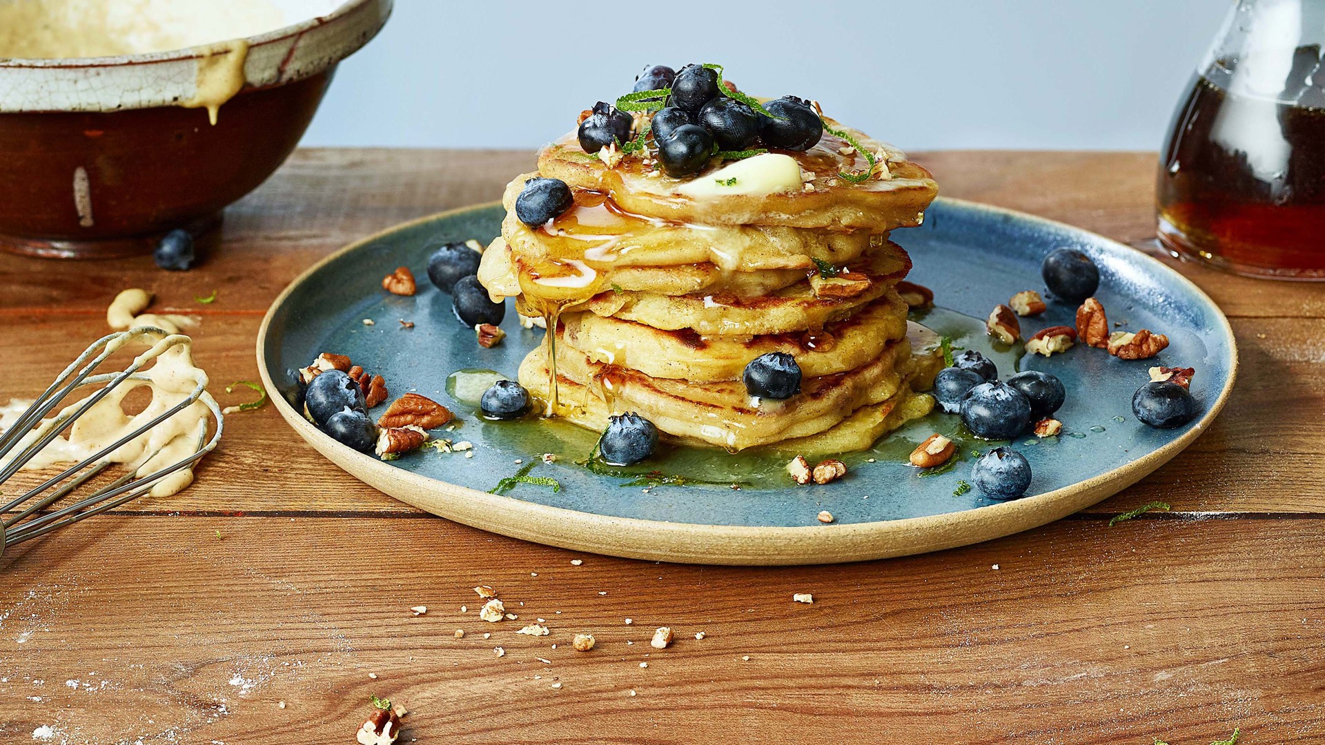 Lime spiked pancakes topped with blueberries, pecans, maple syrup