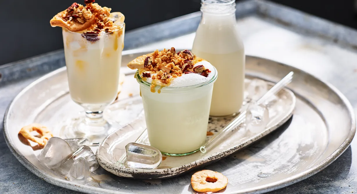 Svalkande och härlig frappe med smak av äppelpaj. Mixa vaniljmjölk skummig med apple pie syrup och krossad is. Häll i höga glas och garnera gärna med crumble, äppelchips, extra syrup och rostade pekannötter.