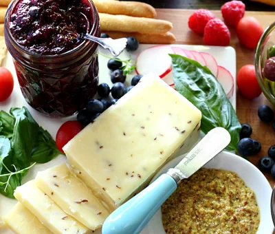 Simple cheese board with double berry chia seed jam