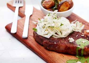 Steak with fennel salad and white cheese spinach sauce