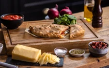 Calzone with spinach sun dried tomato and onion