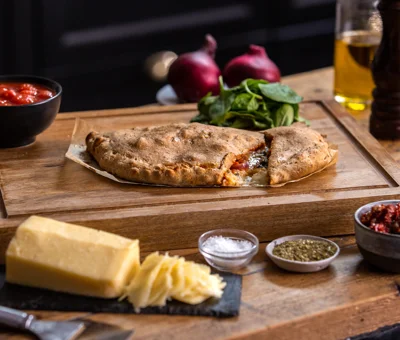 calzone with spinach, sun-dried tomato and onion