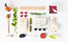Modern spring cheese board with raspberry spread
