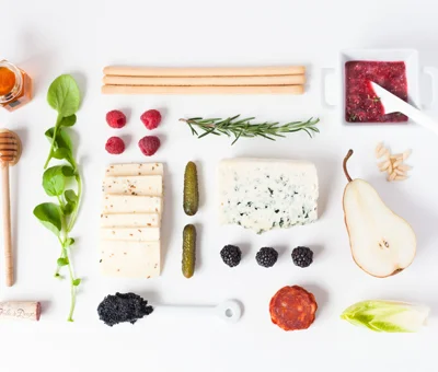 Modern spring cheese board with raspberry spread