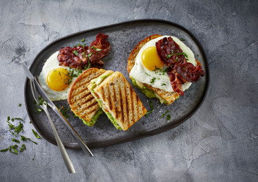 Avocado on toast with eggs and bacon