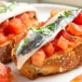 Tostada de tomates caramelizados y anchoas