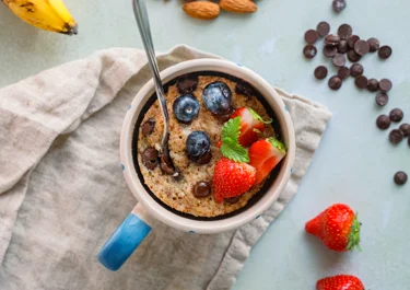 Protein mug cake with chocolate and berries