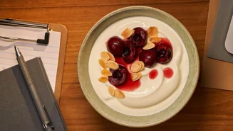 Skyr bowl with preserved cherries and almond flakes