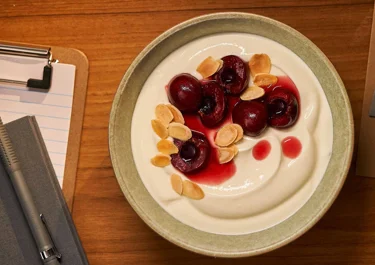 Skyr bowl with preserved cherries and almond flakes
